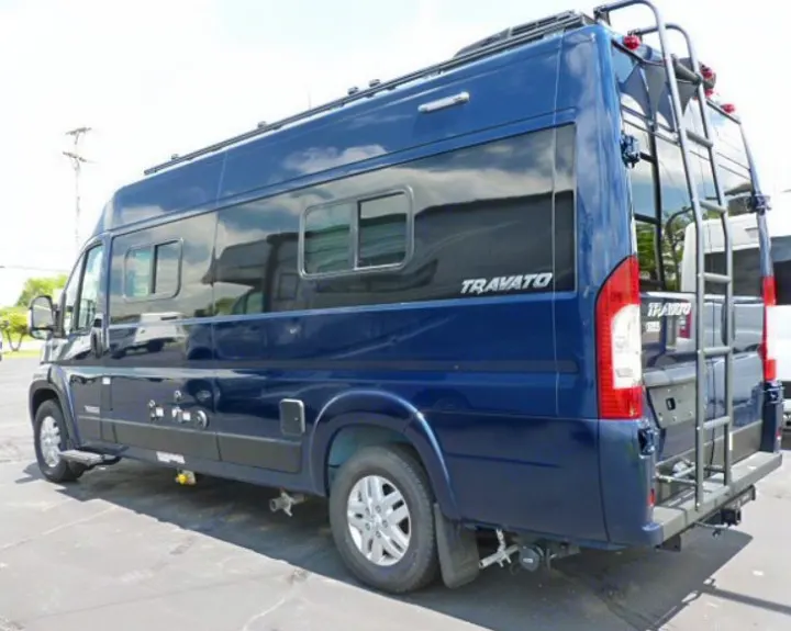 This blue Travato camper van, ideal for RV rental, offers adventure with its sleek design & rear ladder.. Winnebago Travato 2020