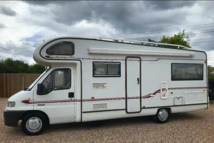 White Autostratus EG SE motorhome. Ideal rv rental with awning & roof rack. Parked on gravel.. Peugeot Boxer Elddis Auto Stratus EB 1999
