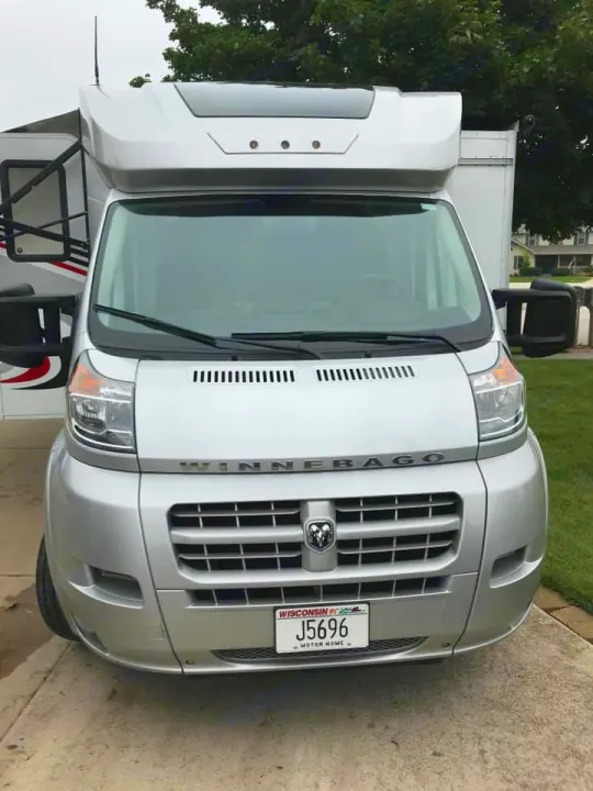 Front view of a silver Winnebago motorhome RV rental, parked on a driveway, ready for your next travel adventure.. Winnebago Trend 2017