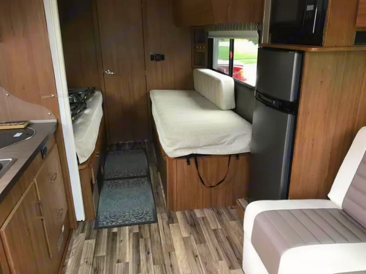 Step into this modern RV rental! The compact interior features a kitchen, bed, sofa, fridge, and microwave, maximizing space for travel comfort.. Winnebago Trend 2017