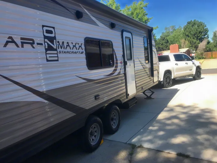 This Starcraft AR-ONE MAXX travel trailer RV rental is hitched to a white pickup truck, ready for its next adventure.. Starcraft Ar-One 2017