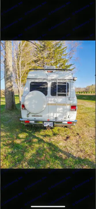 White Chevrolet camper van, ideal for an RV rental adventure, parked on grass. Rear view shows a spare tire and ladder.. Chevrolet G20 1983