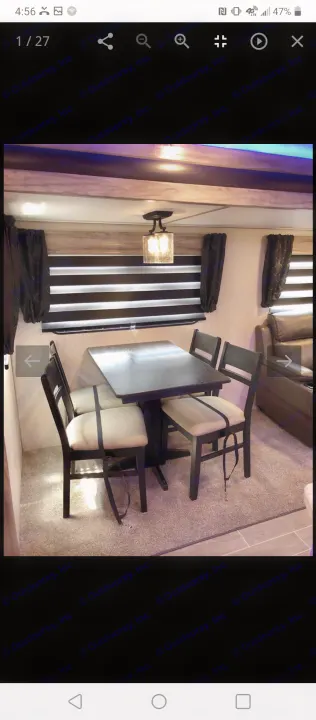 This RV rental offers a well-equipped dining area with a dark table, four secured chairs, and window blinds.. Forest River Cherokee Alpha Wolf 2021