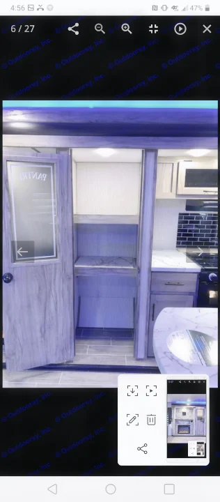 RV rental kitchen featuring a glass-front pantry, modern dark tile backsplash, and sleek countertops. Ideal for travel trailer adventures.. Forest River Cherokee Alpha Wolf 2021