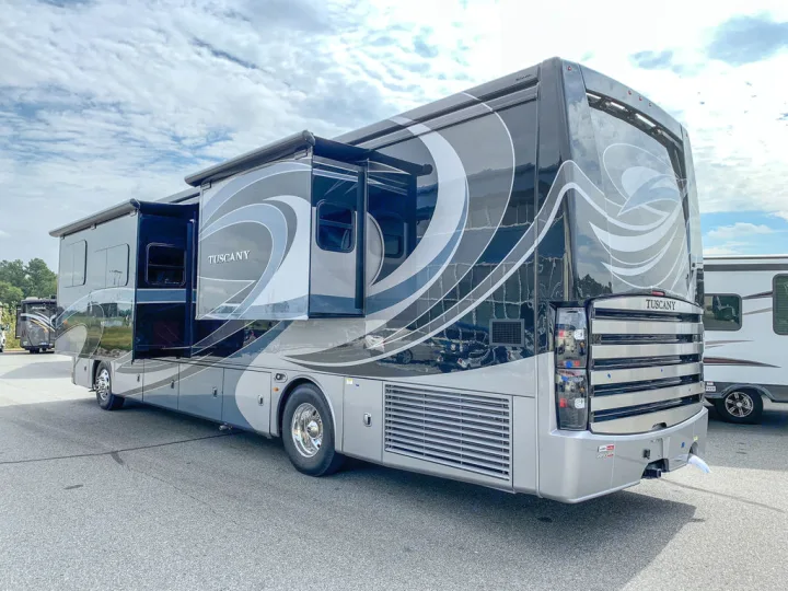 Luxurious gray & black RV rental motorhome with extended slide-outs, ready for your next travel adventure.. Thor Motor Coach Tuscany 2019