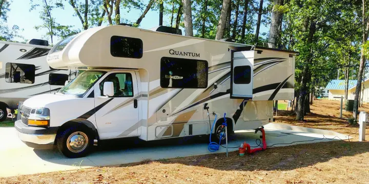 This Quantum RV rental offers full hookups at a spacious, tree-lined campsite. Perfect for outdoor adventures!. Thor Quantum 2020