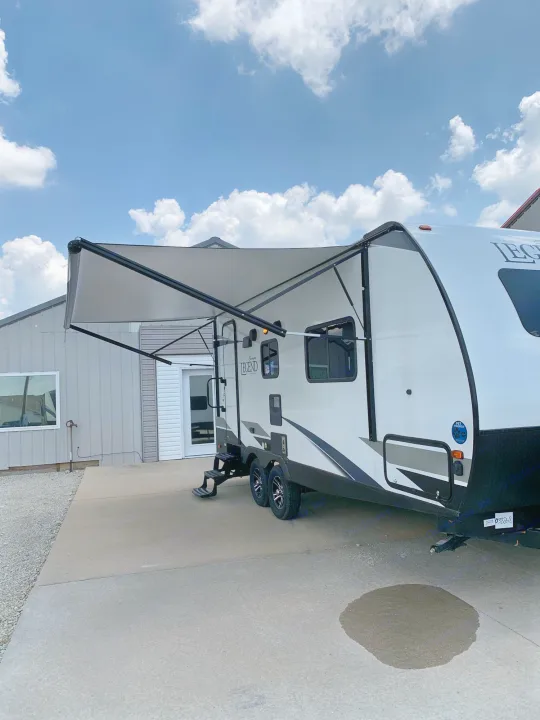 Spacious, pet-friendly travel trailer RV rental with awning extended, parked and ready for adventure.. ForestRiver Surveyor 2020