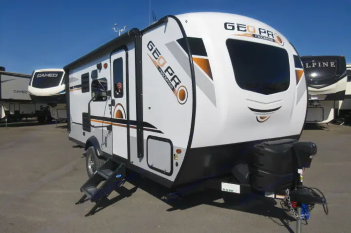 Explore the open road with this white Geo Pro travel trailer RV rental, seen parked outdoors with its steps deployed.. Forest River Rockwood Geo Pro 2021