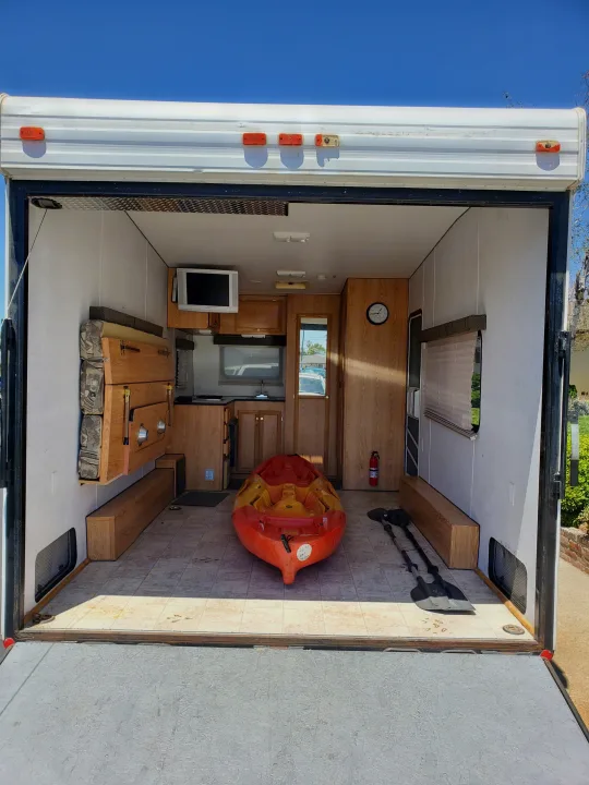 Inside this RV rental toy hauler: a kitchen, fold-down seating, and space for adventures with a kayak and paddles.. Carson Trailer Toy Hauler 2007