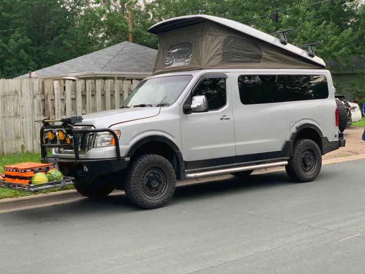 This custom Nissan NV camper van with pop-top tent, perfect for an rv rental, is ready for an off-road adventure, with watermelons too!. Roadtrek N6-Active 2013