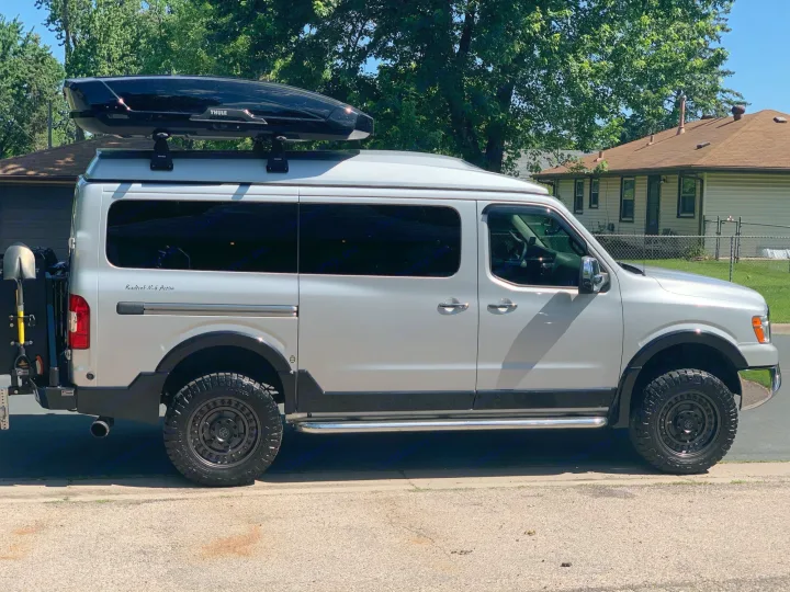 Roadtrek N-6 Active RV rental: a customized silver Nissan NV van with off-road tires, roof box, and adventure gear.. Roadtrek N6-Active 2013