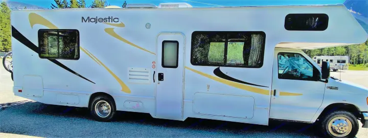 White Majestic RV rental with bike rack, ready for your next outdoor adventure.. Ford Cutaway 2006
