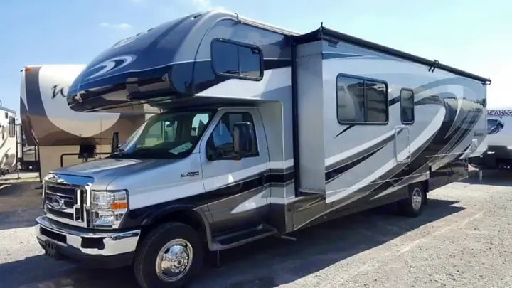 This modern Class C RV rental features sleek silver and black design, parked outside. Ideal for travel.. Forest River Sunseeker LE 2015