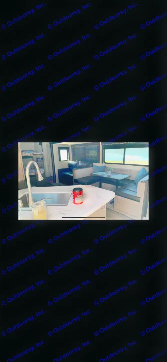 RV rental: Inside a comfortable RV, featuring a kitchen island with sink, dining booth, sofa, and bunk beds.. Keystone Bunkhouse 2020