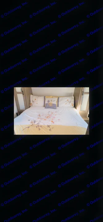 Comfortable RV rental bedroom featuring floral bedding and built-in storage. Ideal for cozy travel accommodations.. Keystone Bunkhouse 2020