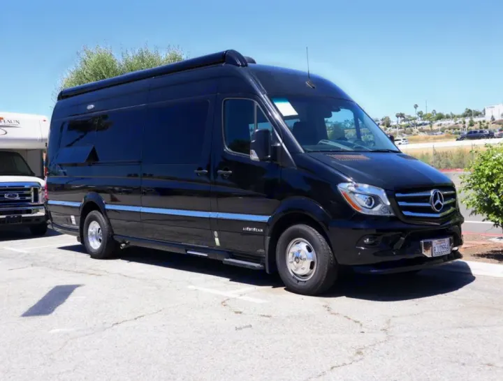 Sleek black Airstream Mercedes Sprinter camper van parked for RV rental. Ready for your next road trip adventure.. Airstream Interstate 2019