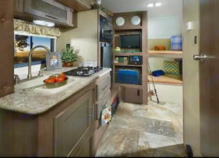 This RV rental offers a compact kitchen with sink & stove, an entertainment center, and two bunk beds. Ideal for travel.. Other Other 2016