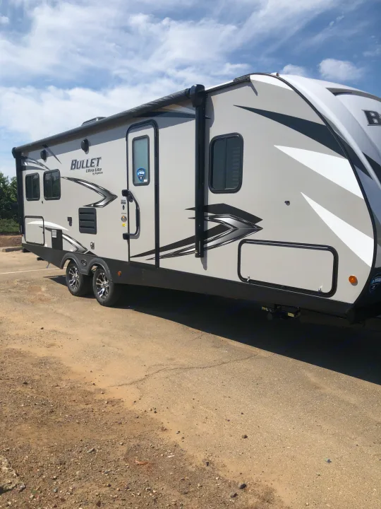 Light gray Bullet Ultra Lite travel trailer, ideal for an RV rental. Enjoy open road adventures & outdoor living.. Keystone Bullet 2021