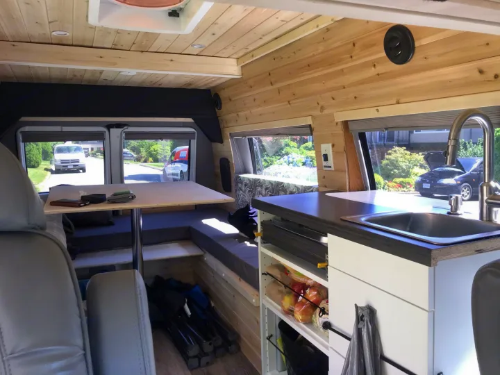 Cozy wrap around bench seating, kitchenette with pull out 2 burner cook top. Dodge B Van 2002