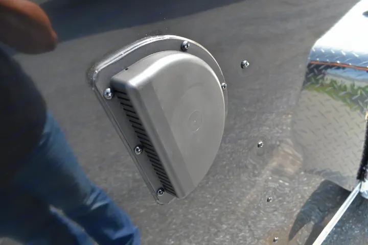 RV rental: A grey vent cover on the dark side, reflecting a person in blue jeans and a diamond plate surface.. LOOK Enclosed  Trailer 2019