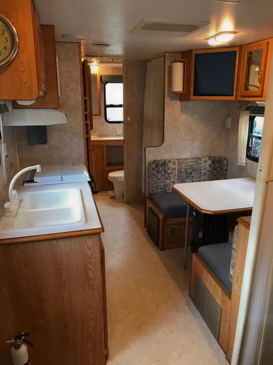 Compact RV rental interior featuring kitchen, dinette, and bathroom. Perfect for your next camper adventure.. Sunline Solaris/Delivery&Set-up 2002