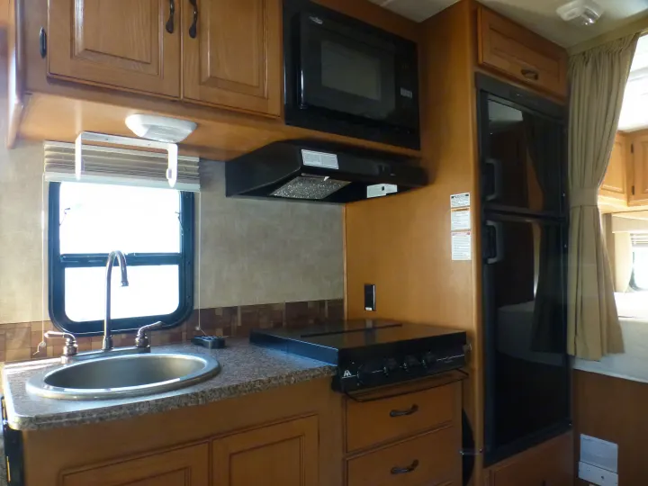deep sink, 3 burner LP stove top, convection/microwave, 2-door fridge/freezer. Coachmen Prism 2150LE 2013