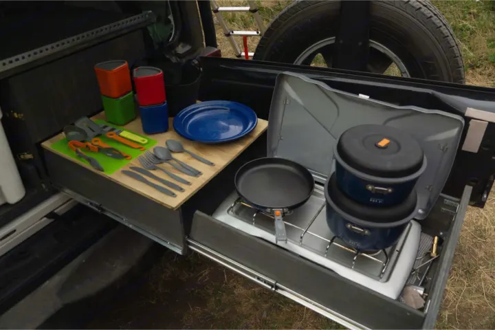 RV rental kitchen setup with pull-out stove, pots, pans, and utensils for easy outdoor cooking. Perfect for camping.. Jeep Wrangler Unlimited 2018