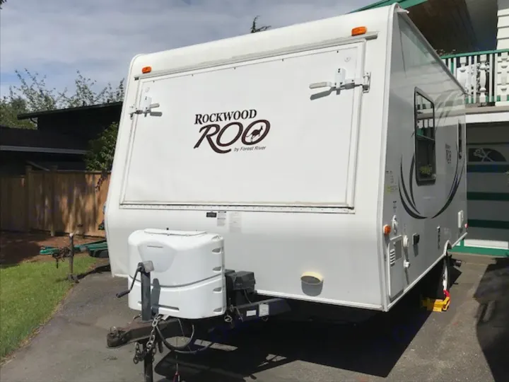 White Rockwood Roo hybrid travel trailer, ideal for an RV rental getaway.. Rockwood Roo 2011