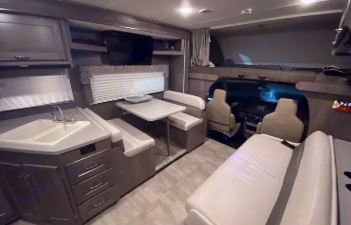 Spacious RV rental interior featuring kitchen, dining, bed, and cockpit area.. Winnebago Winnebago Spirit 2017