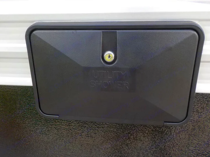 Black utility shower access panel with a lock on an RV rental. Provides outdoor hot/cold water for camping.. Forest River Evo 2021