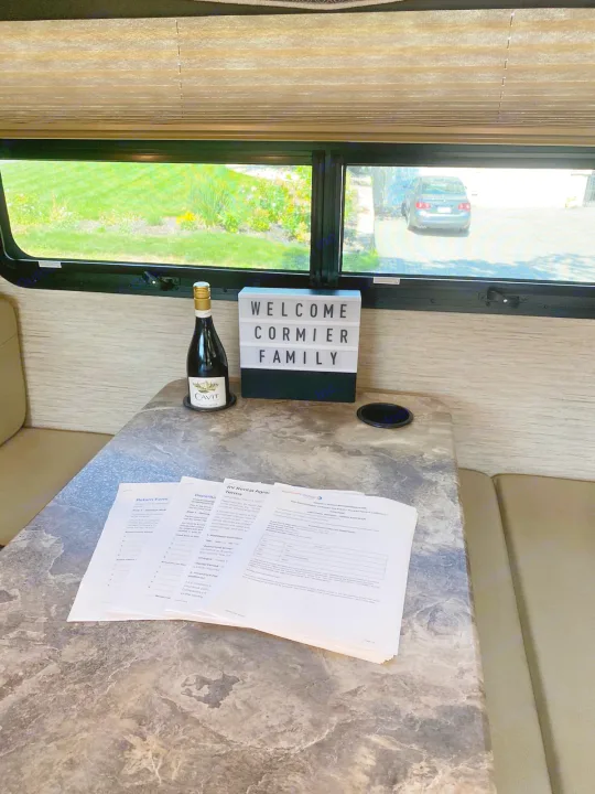 RV rental: Welcome Cormier Family sign, wine, and forms on table.. Thor A.C.E 2020