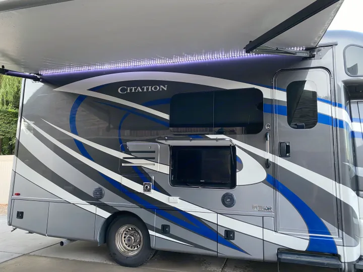 Explore this RV rental: A Thor Citation motorhome with a deployed LED awning and external TV setup.. Thor Motor Coach Citation 2018
