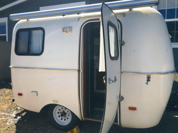 Exterior with awning and little porch light. Scamp 13' 2010