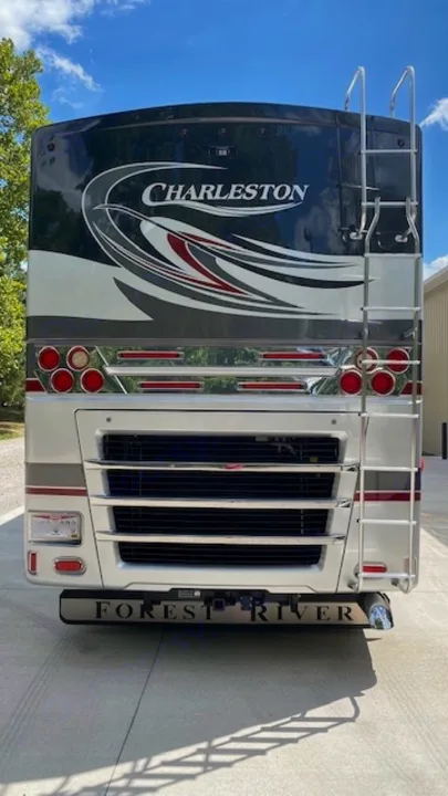 Rear of a Charleston **rv rental** by Forest River. This **motorhome** features a ladder, shiny chrome, and detailed graphics for **travel**.. Charleston Charleston Motorhome 2015