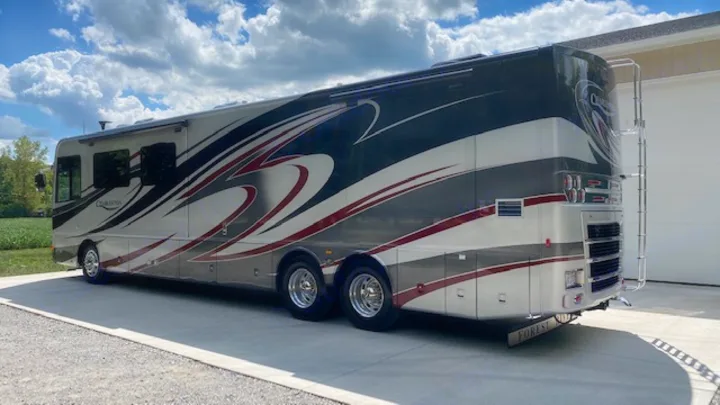 A large, luxurious Charleston motorhome (RV) with a distinctive gray, white, and red design, perfect for an RV rental.. Charleston Charleston Motorhome 2015