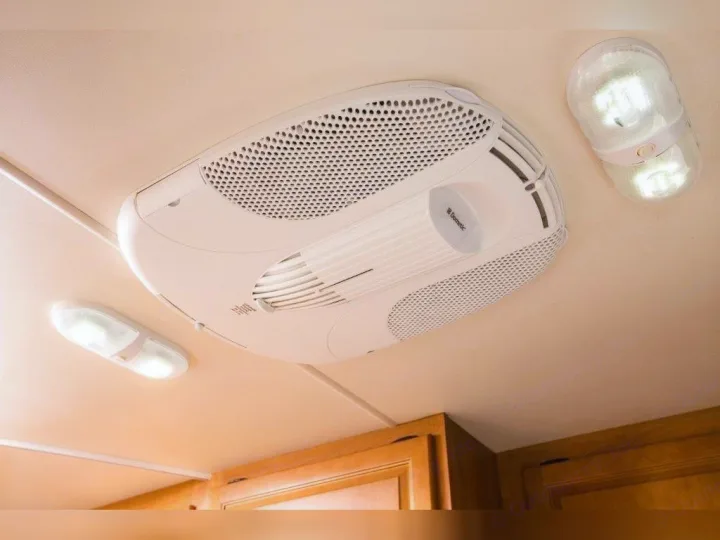 This **RV rental** interior showcases a Dometic air conditioner unit and bright LED ceiling lights, enhancing travel comfort.. Thor Motor Coach Four Winds Majestic 2014