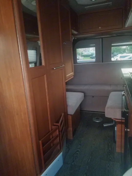 Explore this RV rental's cozy interior: wood. Roadtrek Ssagile 2014