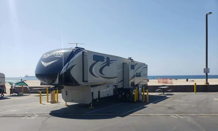 Experience coastal living! This Solitude fifth wheel rv rental sits beachside in a sunny park.. Grand Design Solitude 2016