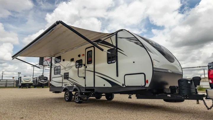 This white Spirit travel trailer with an extended awning is an ideal rv rental for outdoor adventures.. Coachmen Spirit Of America 2019