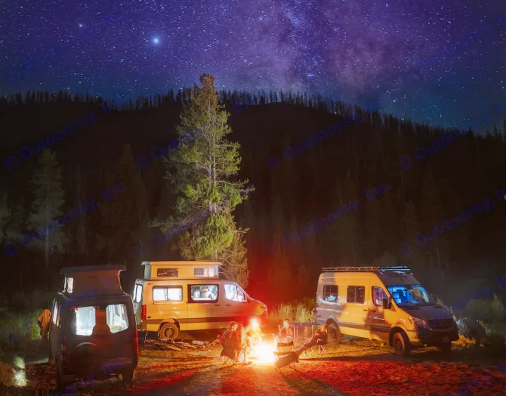 Night sky adventure with RV rental: Three camper vans, people by a campfire in a dark forest under brilliant stars.. Mercedes-Benz Sprinter 2020