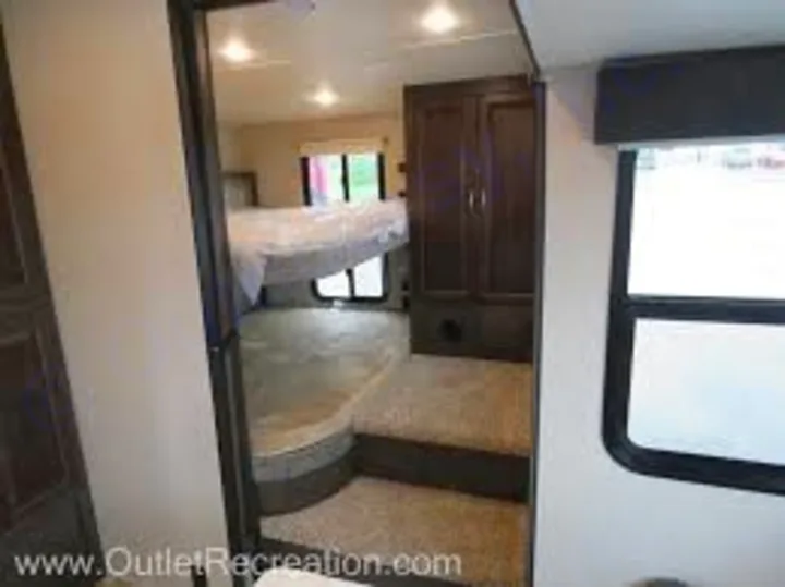 This RV rental features a multi-level bunk bed area with steps and wood cabinetry, ideal for family sleeping comfort.. Coachmen Chaparral 2018