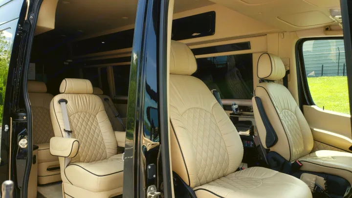 Plush RV rental interior featuring diamond-stitched tan leather seats, armrests, and spacious design.. Mercedes-Benz Sprinter 2015
