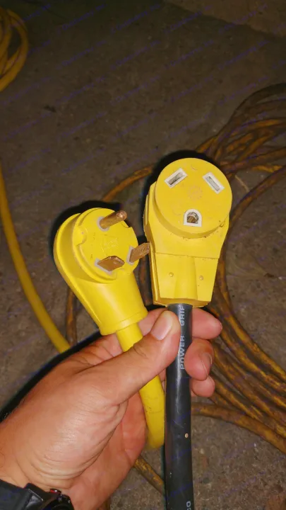 RV rental electrical connectors: Yellow 30-amp male plug and female receptacle for shore power.. Forest River Cherokee Grey Wolf 2013