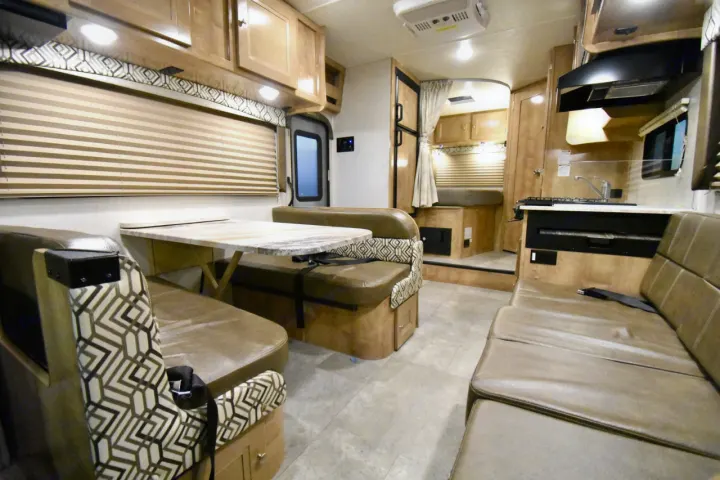 Spacious RV rental interior featuring a well-equipped kitchen, dinette, and cozy living area.. Leprechaun 230RB 2020