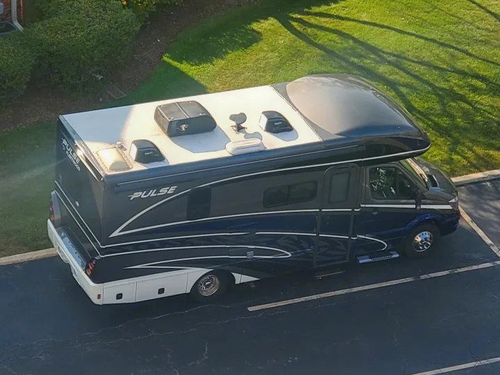 Aerial view of a blue and white Pulse Fleetwood RV rental parked outdoors, showcasing its sleek design.. Fleetwood Pulse 2019