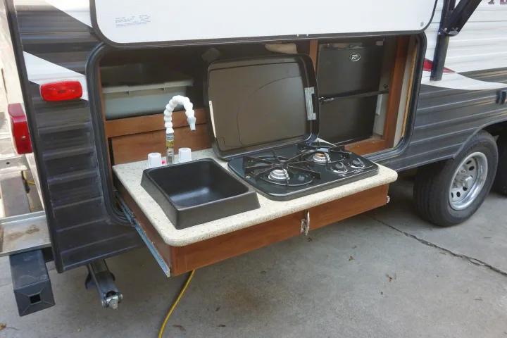 This RV rental features a convenient pull-out outdoor kitchen with a sink, stove, and mini-fridge.. Dutchmen Aspen Trail 2015