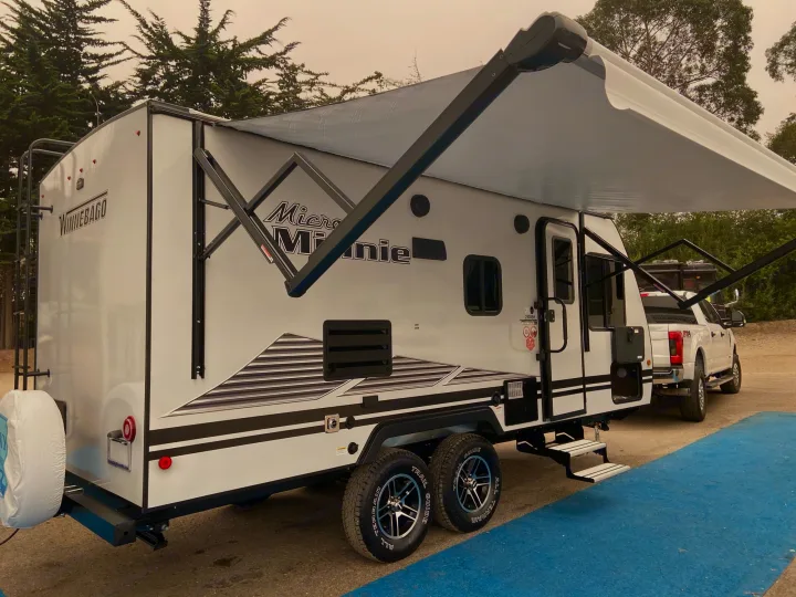 Winnebago Micro Minnie travel trailer RV rental with awning extended, ready for your next outdoor adventure.. Winnebago Micro Minnie 2021