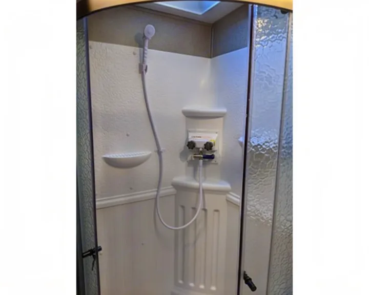 RV rental shower with handheld sprayer, temperature controls, textured door, and skylight.. Forest River Forest River Flagstaff Classic Super Lite 2021