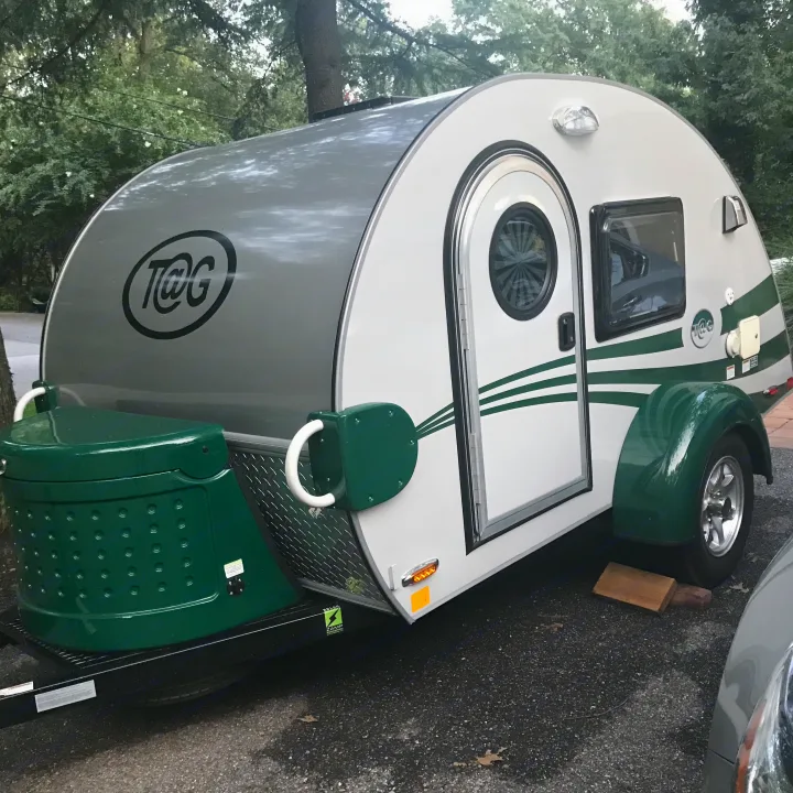 A light grey and green T@G teardrop trailer, a charming RV rental for your next camping trip.. T@G T@G Trailer 2015