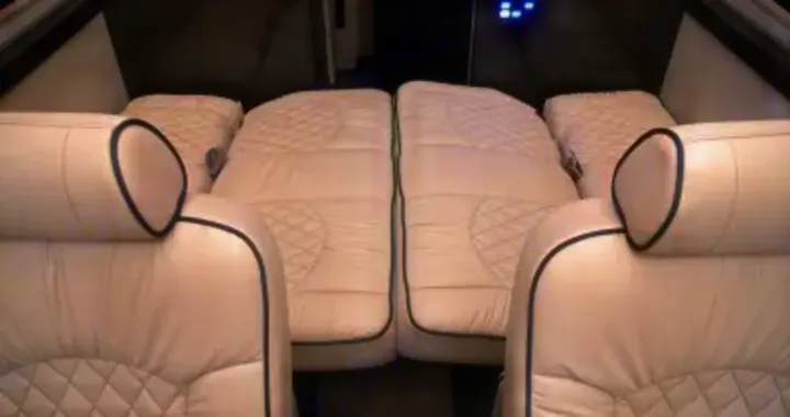 Luxurious RV rental interior with cream quilted seating converted to a comfy bed. Perfect for travel.. Other Other 2020